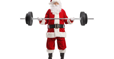 A man in a Santa suit lifts a barbell with change plates near Lexington, Kentucky (KY)