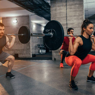 Two men and one woman weight training in a gym around the United States (US)