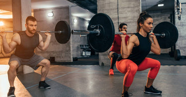 Two men and one woman weight training in a gym around the United States (US)