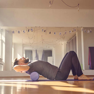 A person stretching out with a foam roller