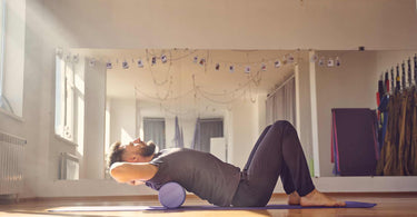 A person stretching out with a foam roller